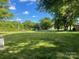 Lawn view of a home with lush green grass and tall trees, offering a glimpse of the neighborhood street at , Salisbury, NC 28147
