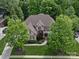 Beautiful brick home with lush green lawn, mature trees, and a welcoming front entrance at 1030 Westbury Dr, Matthews, NC 28104