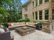 Gorgeous outdoor living space with fire pit and outdoor kitchen, perfect for entertaining at 1030 Westbury Dr, Matthews, NC 28104