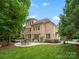 Beautiful backyard with a patio area perfect for outdoor dining and a well-manicured lawn at 1030 Westbury Dr, Matthews, NC 28104