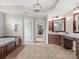 Elegant primary bathroom with double vanity, soaking tub, and lots of natural light at 1030 Westbury Dr, Matthews, NC 28104