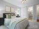 Comfortable bedroom with gray walls, natural light, and an ensuite bathroom provides a relaxing retreat at 1030 Westbury Dr, Matthews, NC 28104