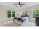 Bedroom featuring neutral walls, a ceiling fan, and dual windows, offering ample natural light at 1030 Westbury Dr, Matthews, NC 28104