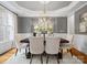 Elegant dining room with a tray ceiling, sophisticated chandelier, and seating for six at 1030 Westbury Dr, Matthews, NC 28104
