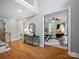 Welcoming foyer with hardwood floors, a staircase, and an open view to a sunlit office at 1030 Westbury Dr, Matthews, NC 28104