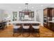 Modern kitchen features a large island with bar seating, hardwood floors, and designer lighting fixtures at 1030 Westbury Dr, Matthews, NC 28104