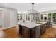 Eat-in kitchen features a large island with modern appliances, a breakfast nook, and hardwood flooring at 1030 Westbury Dr, Matthews, NC 28104