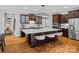 Upscale kitchen boasts a large island with barstools, hardwood floors, and modern appliances perfect for cooking at 1030 Westbury Dr, Matthews, NC 28104