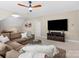 Spacious living room featuring a ceiling fan, large windows, and a comfortable sectional couch at 1030 Westbury Dr, Matthews, NC 28104