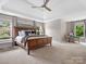 Spacious primary bedroom with tray ceiling, soft carpet, and lots of natural light at 1030 Westbury Dr, Matthews, NC 28104