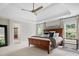 Large primary bedroom with tray ceiling, soft carpet, and lots of natural light at 1030 Westbury Dr, Matthews, NC 28104