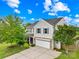 Charming two-story home with light grey siding, two-car garage, and lush green lawn at 105 Altondale Dr, Statesville, NC 28625