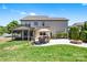 Expansive backyard features a paver patio with dining set, an umbrella, a fire pit, and a screened porch at 106 Sweet Briar Dr, Fort Mill, SC 29707