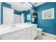 Blue bathroom featuring a double sink vanity, shelving, and natural light at 106 Sweet Briar Dr, Fort Mill, SC 29707