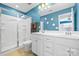Bright bathroom features a glass-enclosed shower, a double sink vanity, and flower accents on the wall at 106 Sweet Briar Dr, Fort Mill, SC 29707