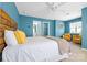 Light-filled bedroom features stylish décor, a wood headboard, and access to a bathroom and walk-in closet at 106 Sweet Briar Dr, Fort Mill, SC 29707