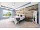 Bright bedroom showcasing a wood accent wall and natural light from the window at 106 Sweet Briar Dr, Fort Mill, SC 29707