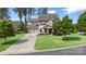 Beautiful home with a well-manicured lawn, long driveway, and mature trees under a blue sky at 106 Sweet Briar Dr, Fort Mill, SC 29707