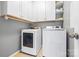 Functional laundry room boasts a washer and dryer, tile flooring, and plenty of cabinet storage at 106 Sweet Briar Dr, Fort Mill, SC 29707