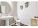 Stylish half bathroom featuring a pedestal sink, shiplap accent wall, and modern fixtures at 106 Sweet Briar Dr, Fort Mill, SC 29707