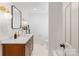 Modern bathroom featuring a wooden vanity, marble countertop, and chic fixtures offer an elevated experience at 1314 Ordermore Ave, Charlotte, NC 28203