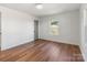 Bright bedroom featuring beautiful wood floors, a window, and neutral walls at 1314 Ordermore Ave, Charlotte, NC 28203