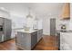 Bright kitchen features a central island with sink, stainless steel appliances, and white cabinets at 1314 Ordermore Ave, Charlotte, NC 28203