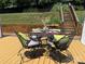 Outdoor living space features a table set for four on a spacious back deck at 1404 River Dr, Belmont, NC 28012