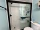 Modern bathroom featuring white tile shower, glass door, and black hardware at 1404 River Dr, Belmont, NC 28012