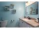 Bright bathroom with a vanity, sink, and decorative shelves, providing ample storage at 1404 River Dr, Belmont, NC 28012