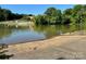 Tranquil lake waters with a public boat ramp and trees in the background at 1404 River Dr, Belmont, NC 28012
