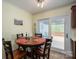 Cozy dining area with a wooden table, four chairs, and sliding glass doors to the backyard at 1404 River Dr, Belmont, NC 28012
