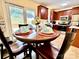 Charming dining area featuring a wooden table, seating for four, and a view of the backyard at 1404 River Dr, Belmont, NC 28012