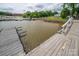 View of the lake from the wooden dock featuring boat slips, slips, and lovely water views at 1404 River Dr, Belmont, NC 28012