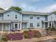 Beautiful townhome with a well-manicured front yard and cozy seating area at 1404 River Dr, Belmont, NC 28012