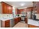 Stylish kitchen featuring stainless steel appliances, quartz countertops, and wooden cabinetry at 1404 River Dr, Belmont, NC 28012