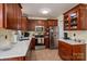 Well-equipped kitchen with stainless steel appliances, cherry cabinets, and bright countertops at 1404 River Dr, Belmont, NC 28012
