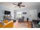 Bright living room with modern decor, including a flat-screen TV, soft chairs, and a wooden floor at 1404 River Dr, Belmont, NC 28012