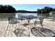 Lakeside pier featuring metal outdoor dining set overlooking calm river at 1404 River Dr, Belmont, NC 28012