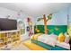 Bright bedroom with hand painted murals, colorful bed and playful decor at 14311 Riding Hill Ave, Charlotte, NC 28213