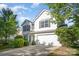 Well-maintained two-story home with attached two car garage, complemented by manicured landscaping at 14311 Riding Hill Ave, Charlotte, NC 28213