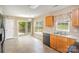 Bright eat-in kitchen features sliding glass doors to the backyard and ample counter space at 14311 Riding Hill Ave, Charlotte, NC 28213