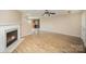 Spacious living room features a fireplace, wood floors, and lots of natural light at 14311 Riding Hill Ave, Charlotte, NC 28213