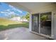 Back patio view featuring a grassy backyard area enclosed by a rustic wooden fence at 14311 Riding Hill Ave, Charlotte, NC 28213