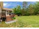 Spacious backyard with a lawn, flower beds, and a screened-in porch with a grill at 1680 Beleek Ridge Ln, Clover, SC 29710
