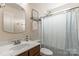 This full bathroom has a dark vanity, shower with tub, decorative mirror, and plenty of space at 1680 Beleek Ridge Ln, Clover, SC 29710