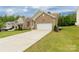 Beautiful home featuring a spacious driveway and well-maintained front yard at 1680 Beleek Ridge Ln, Clover, SC 29710