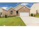Charming brick home with well-manicured lawn, two-car garage, and inviting curb appeal at 1680 Beleek Ridge Ln, Clover, SC 29710