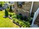 Charming landscaping featuring green hostas and flowering plants, adding curb appeal to this brick home at 1680 Beleek Ridge Ln, Clover, SC 29710