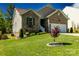 Beautiful brick home featuring lush front yard, manicured landscaping, and an attached garage at 1680 Beleek Ridge Ln, Clover, SC 29710
